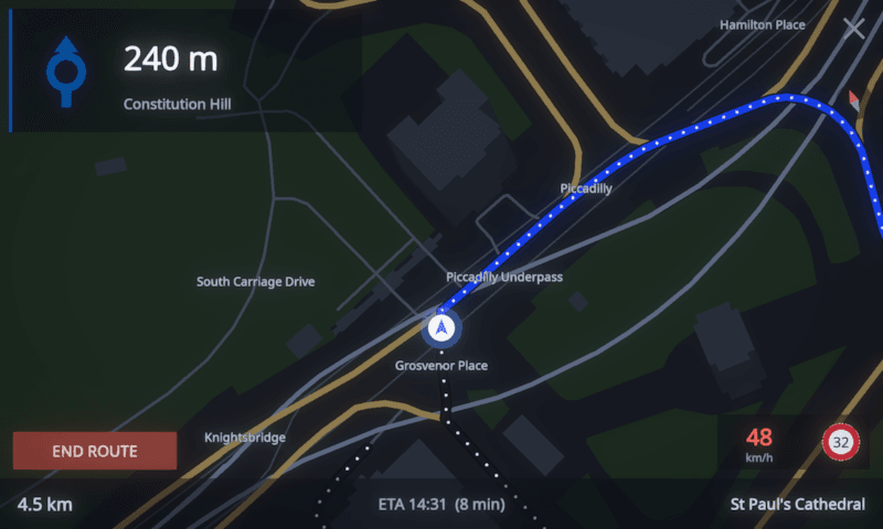 MotoCore One navigation follow mode with a heading-up map, a roundabout card at 240 m for Constitution Hill, and a red 48 km/h speed chip beside the 32 km/h limit roundel