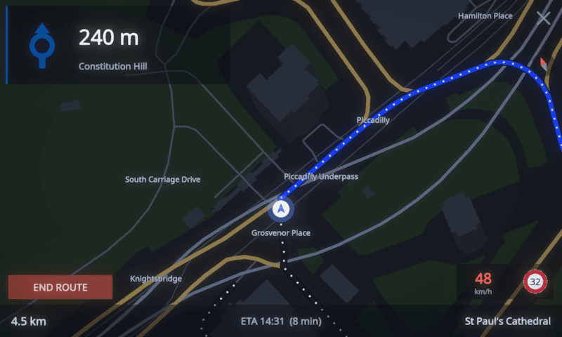 MotoCore One navigation follow mode, a heading-up map with next-manoeuvre card and a red 48 km/h speed chip beside the 32 km/h limit roundel